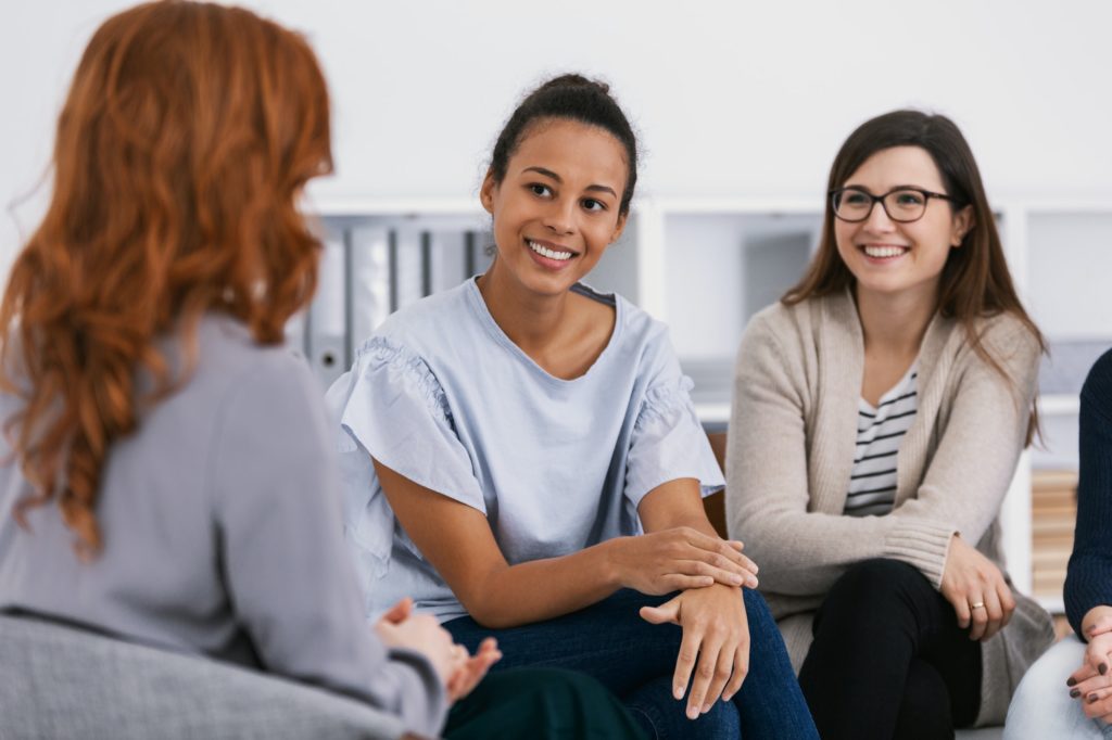 Women with problems sitting together during counseling